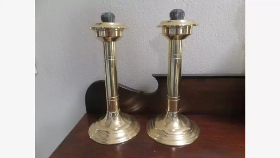 R690 Pair of brass spring loaded candlesticks